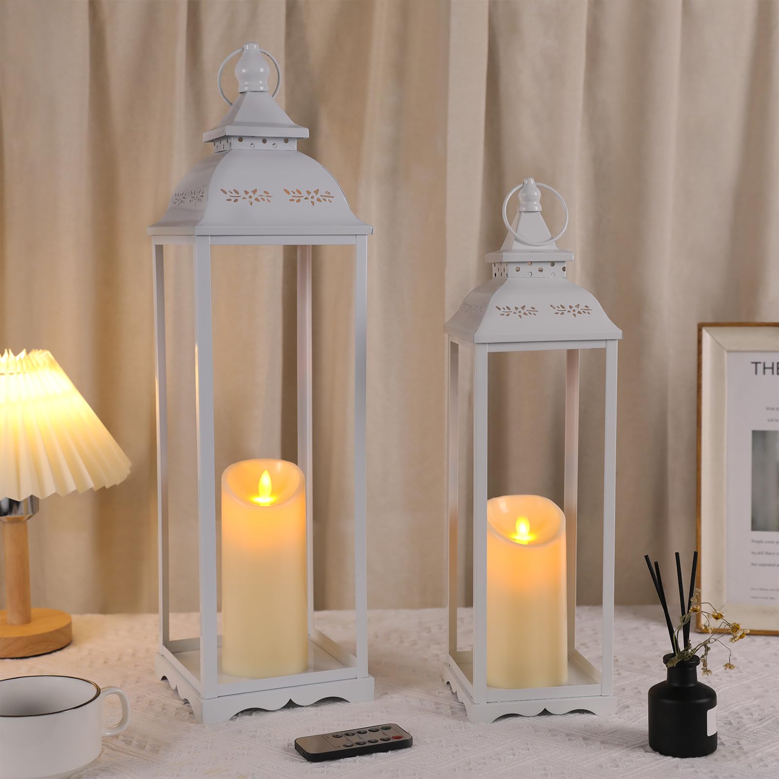 HAVITI 2 Pack Large Lanterns, White Metal Decorative Indoor/Outdoor, 22in & 17in, with 2 Flameless Candles, Farmhouse Style