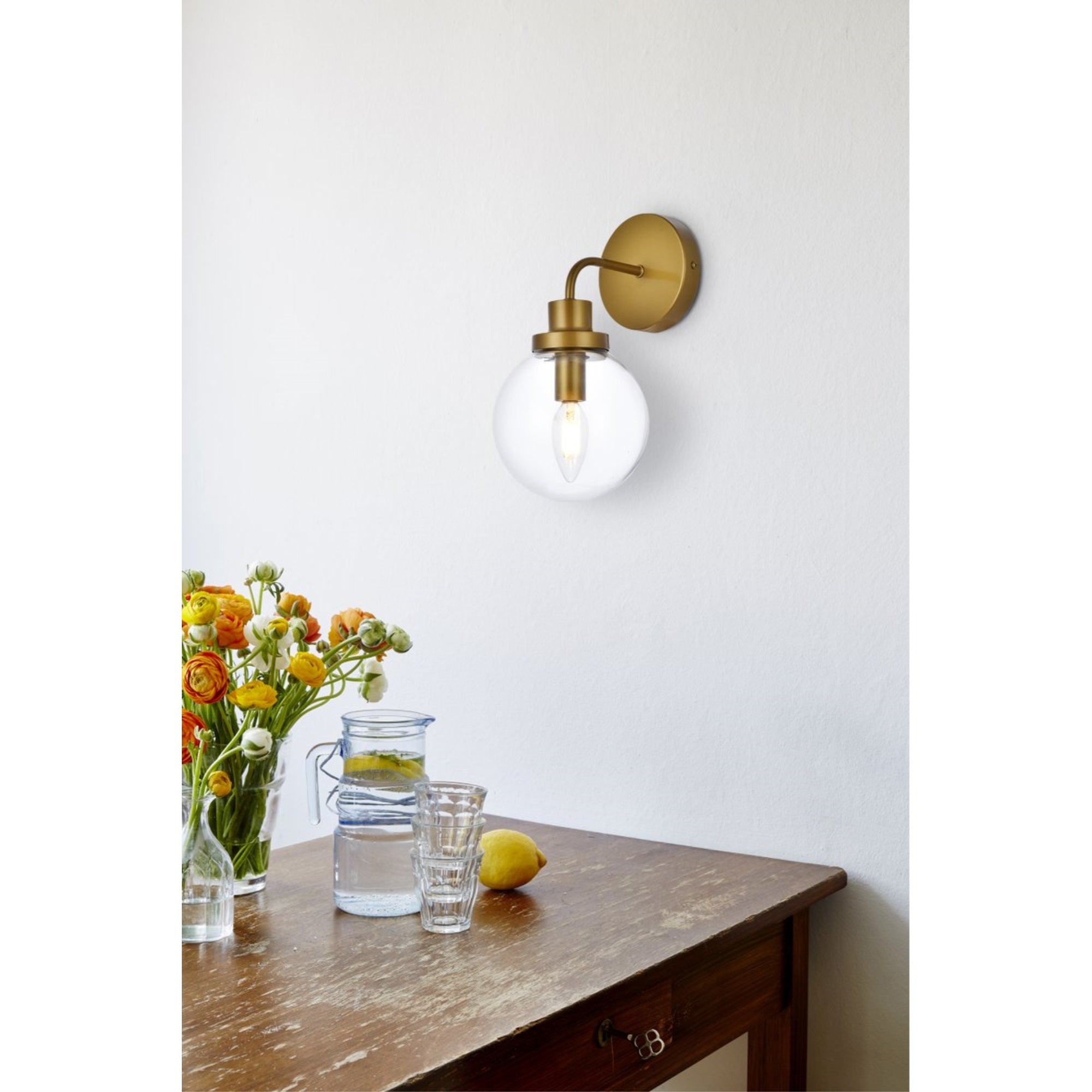Hanson 1 light bath sconce in brass with clear shade