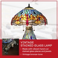 This unique Dragonfly Table Lamp has been handcrafted using methods first developed by Louis Comfort Tiffany The shade contains pieces of stained glass each handcut and wrapped in fine copper foil in rich tones of blue Red dragonflies accent the shade Thi