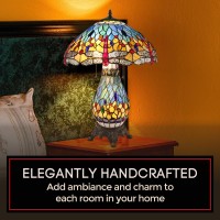 This unique Dragonfly Table Lamp has been handcrafted using methods first developed by Louis Comfort Tiffany The shade contains pieces of stained glass each handcut and wrapped in fine copper foil in rich tones of blue Red dragonflies accent the shade Thi