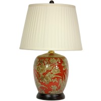 Melon jar shaped porcelain ceramic lamp in a rich red color with an intricate floral pattern in beige and brown Lamp is mounted on a round rosewood base and ships with a pleated white lamp shade and decorative finial UL approved hardware uses standard US 