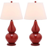 Casting a colorful glow in any room the sparkling Chinese red Cybil Double Gourd Glass Lamp is adorned with coordinating red finial base and neck Topped with a beautifully tapered pure cotton shade that illuminates the room Assembly required this lamp mea