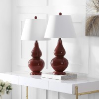 Casting a colorful glow in any room the sparkling Chinese red Cybil Double Gourd Glass Lamp is adorned with coordinating red finial base and neck Topped with a beautifully tapered pure cotton shade that illuminates the room Assembly required this lamp mea