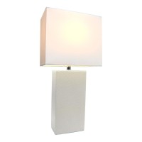 This fashionable table lamp with its leather body and white fabric shade will add style and pizzazz to any room We believe that lighting is like jewelry for your home Our products will help to enhance your room with elegance and sophisticationFeaturesLeat