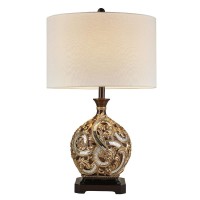 Add a sophisticated touch to your home with this opulent table lamp Beautifully crafted with a unique pattern of mirrored mosaic pieces that adorn the base Brushed with a gold leaf pattern and brown footed base The drum shade is beige with a subtle accent