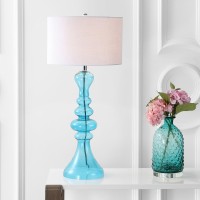 Exemplifying one of the hottest trends in home dcor the irregular curvature of this extra tall table lamp brings style to any setting Finished with a matching finial and white linen drum shade this piece would be equally at home in a foyer or at your beds