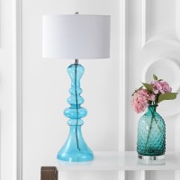 Exemplifying one of the hottest trends in home dcor the irregular curvature of this extra tall table lamp brings style to any setting Finished with a matching finial and white linen drum shade this piece would be equally at home in a foyer or at your beds