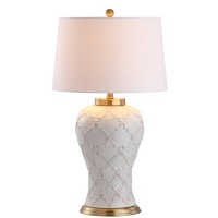 Featuring a creamcolored glaze and quatrefoil trellis texture this transitional table lamp boasts modern elegance to complement any contemporary decor The hardback linen shade offers sleek contrast to the textured base while the brass pedestal fittings an