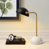 Convey is a chic midcentury inspired table lamp perfect for your home office desk or living room accent table The round white marble base offers a striking contrast to the updown adjustable black metal shade while the bronze finish on the stem completes t