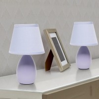 A lovely inexpensive and practical table lamp set to meet your basic fashion lighting needs These mini lamps feature an oval shaped ceramic base and matching fabric shades Perfect for living room bedroom office kids room or college dorm