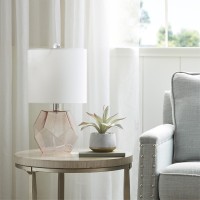 pElevate your home decor with the unique style of the 510 Design Bella Table Lamp This table lamp features a pink glass base with a white drum shade that creates a beautiful and eyecatching contrast A 60inch clear cord provides plenty of length to fit thi