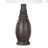 Add sophistication and charm at your living space by the inclusion of this eye catching table lamp available in a set of 2 It features a bellied resin body with ribbed details incorporating a 3 way switch for control and a tapered fabric shade that uses a