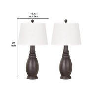 Add sophistication and charm at your living space by the inclusion of this eye catching table lamp available in a set of 2 It features a bellied resin body with ribbed details incorporating a 3 way switch for control and a tapered fabric shade that uses a