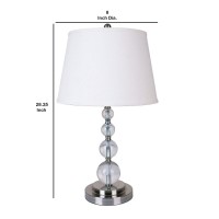 Glorify your furnishing with the inclusion of this contemporary style Table Lamp Incorporating a drum shape fabric shade in the hue of white it is supported on a round steel base complemented with ascending faux crystal orb accents With its appealing aest