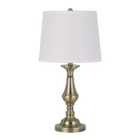 Elevate your sense of style and choice with the inclusion of this sturdily constructed table lamp available in set of 2 The turned pedestal style body in brass hue adds a touch of vintage and antique appeal to it The tapered drum shade compliments its loo