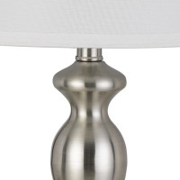 Oozing of elegance and glamorous appeal this table lamp available in set of 2 depicts perfection in its purest form The turned style body accented in silver color hue makes it appear charming and a stand alone addition The faux silk fabric shade adds rega