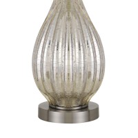 The beautiful table lamp available in set of 2 will bring the most desired addition in the bedroom interior The clear hue of this piece can blend well with any interior setting The bowling pin design body embellished with crackle finish and textured lines