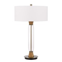 With Clean and smooth lines this crystal column table lamp will add modern charm to any space It features a slim cylindrical body with antique brass and oak wood accents The lamp ships complete with a white fabric hardback drum shade