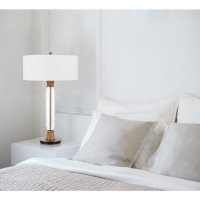 With Clean and smooth lines this crystal column table lamp will add modern charm to any space It features a slim cylindrical body with antique brass and oak wood accents The lamp ships complete with a white fabric hardback drum shade