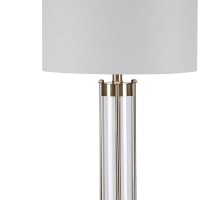 Perfect for a study desk or home office this elegant Table Lamp lends contemporary appeal to your home Supported on a stacked base accented with golden brass finish it incorporates a drum shape white fabric shade It elevates the aesthetics of any home and