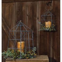 Open Air Lanterns are a set of two gray metal lanterns with a lightly distressed rusty finish Each lantern has a holder on the bottom to fit a votive or pillar sized candle They can be displayed on a table or hung by the metal ring from the top of each la