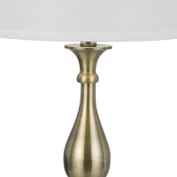 Oozing of elegance and glamorous appeal this table lamp available in set of 2 depicts perfection in its purest form The turned style body accented in golden color hue makes it appear charming and a stand alone addition The faux silk fabric shade adds rega