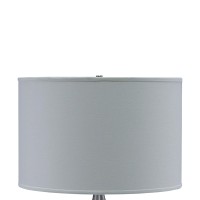 Style up your living space with a contemporary touch by bringing in this sophisticated table lamp Featuring a pot bellied ceramic body it showcases stylish horizontal textured details with metal accents It is incorporated with a fabric drum shade that use