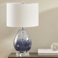 pUrban Habitat Borel Table Lamp Beautifully designed this glass table lamp flaunts a blue hue that adds a soft touch of color to your room The cream drumshaped lamp shade tastefully accents the base while softly filtering the light to give off a warm glow