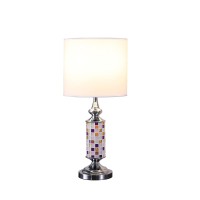 Brighten up your aesthetics like never before with the inclusion of this table lamp Crafted from metal it has a cylindrical body with a glass cut out mosaic pattern that adds to the beauty The uno fitter shade allows the light to filter through it The on 