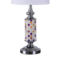 Brighten up your aesthetics like never before with the inclusion of this table lamp Crafted from metal it has a cylindrical body with a glass cut out mosaic pattern that adds to the beauty The uno fitter shade allows the light to filter through it The on 