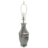 Crafted from durable ceramic this stylish table lamp adds a bright splash of confidence to your interior The urn shaped body with textured lines add an elegant and classic flair to the piece while the elongated round fabric shade with a finial on top give