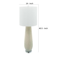 With a natural and comforting aesthetic this table lamp is a calm addition to your interior design The elongated rounded body with textured lines adds a finesse and creative look to it The elongated fabric drum shade filters light for a pleasant glow Sold