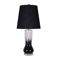 Elegant and artfully crafted this table lamp is a versatile statement piece for any bedroom living room or family space The subtly vase shaped base with a dual tone black and white painted finish give this piece uniqueness and character it will certainly 