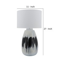 Elegant and artfully crafted this table lamp is a versatile statement piece for any bedroom living room or family space The subtly vase shaped base with a dual tone black and white painted finish give this piece uniqueness and class it will certainly be y