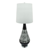 Elegant and artfully crafted this table lamp is a versatile statement piece for any bedroom living room or family space The dramatically tapered vase shaped base with a dual tone black and white tribal painted finish give this piece uniqueness and charact