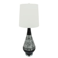 Elegant and artfully crafted this table lamp is a versatile statement piece for any bedroom living room or family space The dramatically tapered vase shaped base with a dual tone black and white tribal painted finish give this piece uniqueness and charact