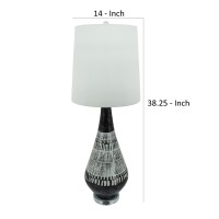 Elegant and artfully crafted this table lamp is a versatile statement piece for any bedroom living room or family space The dramatically tapered vase shaped base with a dual tone black and white tribal painted finish give this piece uniqueness and charact