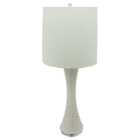 This unique and well crafted table lamp is inspired by seashells with its tapered and textured white ceramic body The white finished drum shade adds a sense of cleanliness and serenity to the naturalistic looking piece The piece has a calm and simple aura