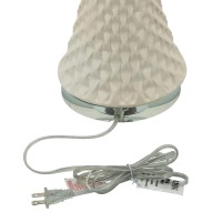 This unique and well crafted table lamp is inspired by seashells with its tapered and textured white ceramic body The white finished drum shade adds a sense of cleanliness and serenity to the naturalistic looking piece The piece has a calm and simple aura