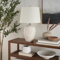 Bring raw beauty to your surroundings with this modern table lamp Made from ceramic in a classic urn shape it adds a distinctively organic vibe to your side table or nightstand Enjoy a relaxing vibe with its tapered drum shade that diffuses a cool glow